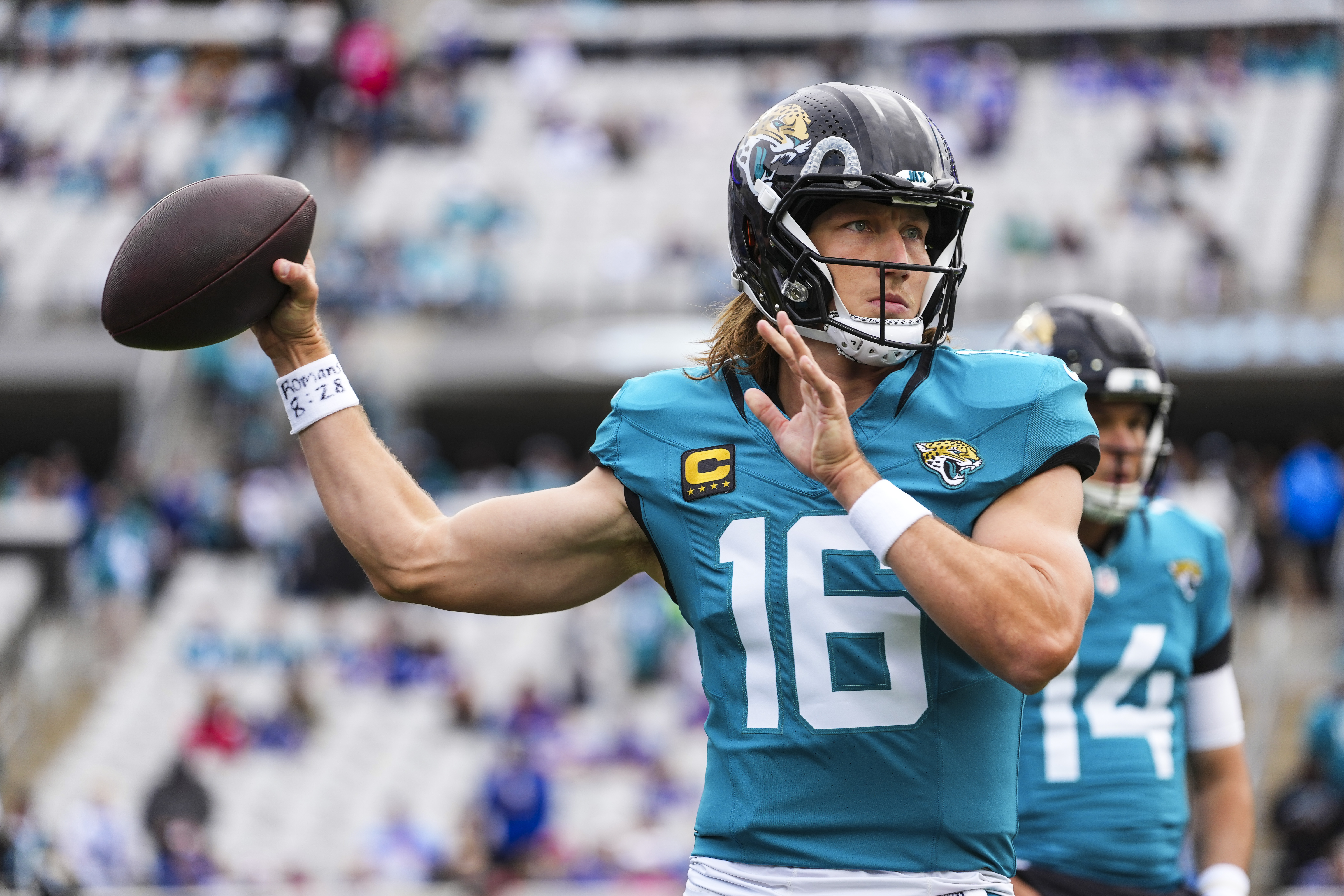 Trevor Lawrence throws a pass while warming up before the Jacksonville Jaguars-Buffalo Bills playoff game.