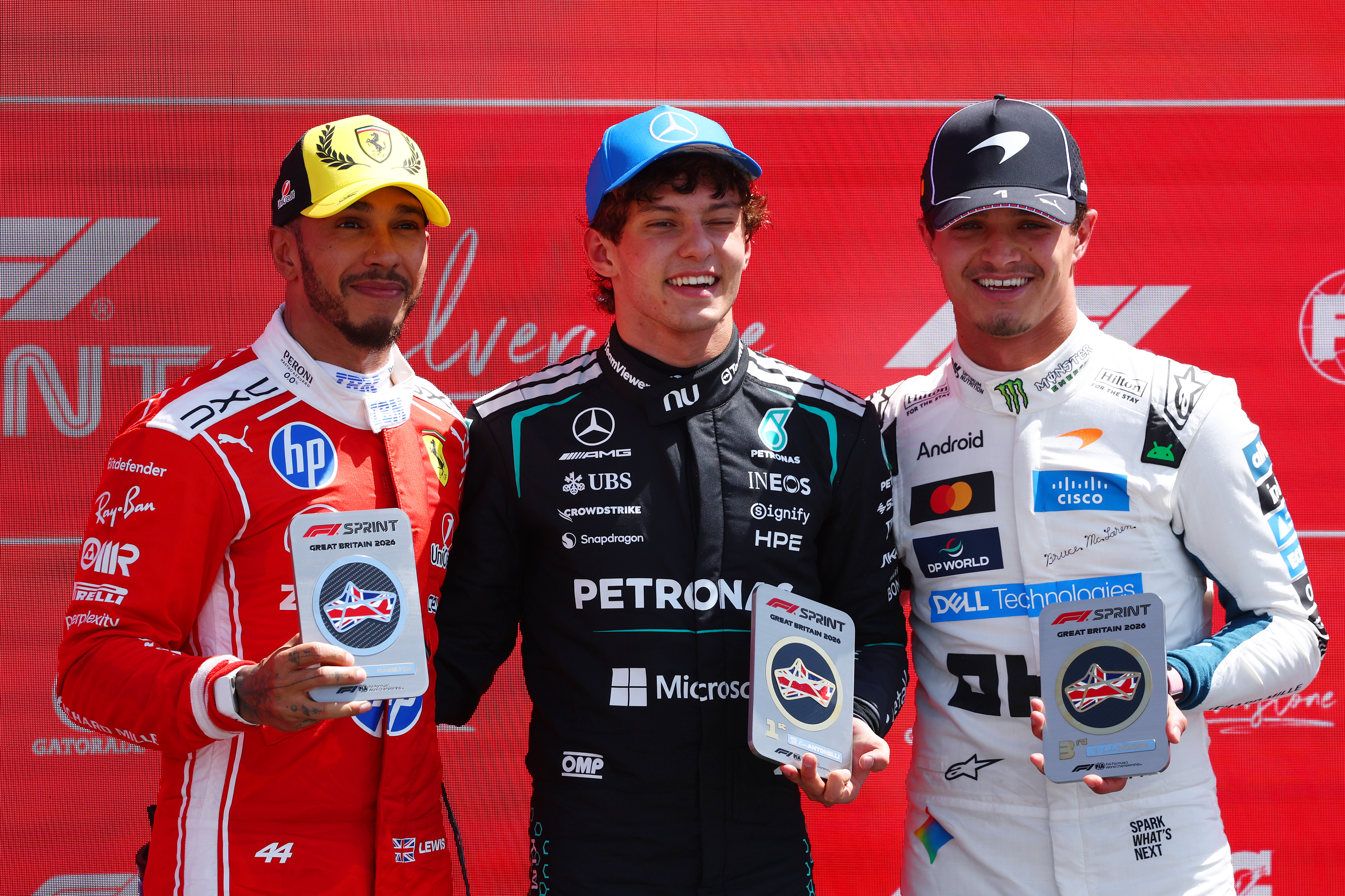 Lewis Hamilton, Kimi Antonelli, and Lando Norris, and Oscar Piastri pose together prior to 2026 F1 Grand Prix of Britain.