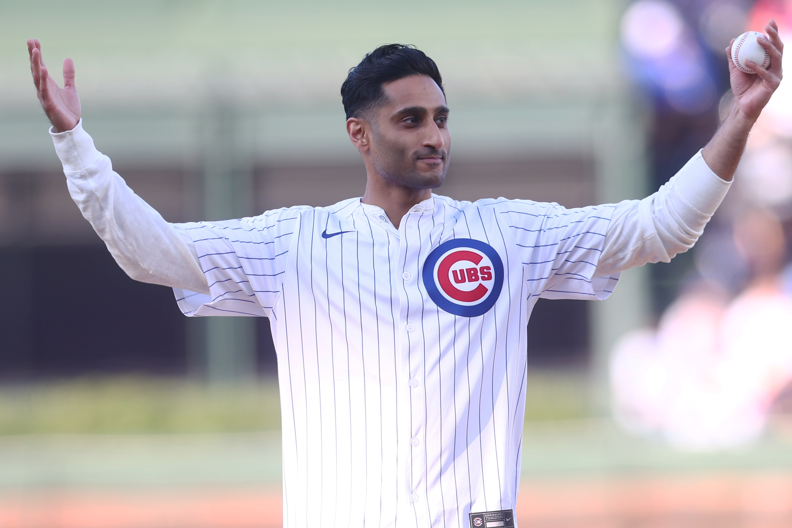 Shama Charania throws out the first pitch at Wrigley Field in April 2025. 