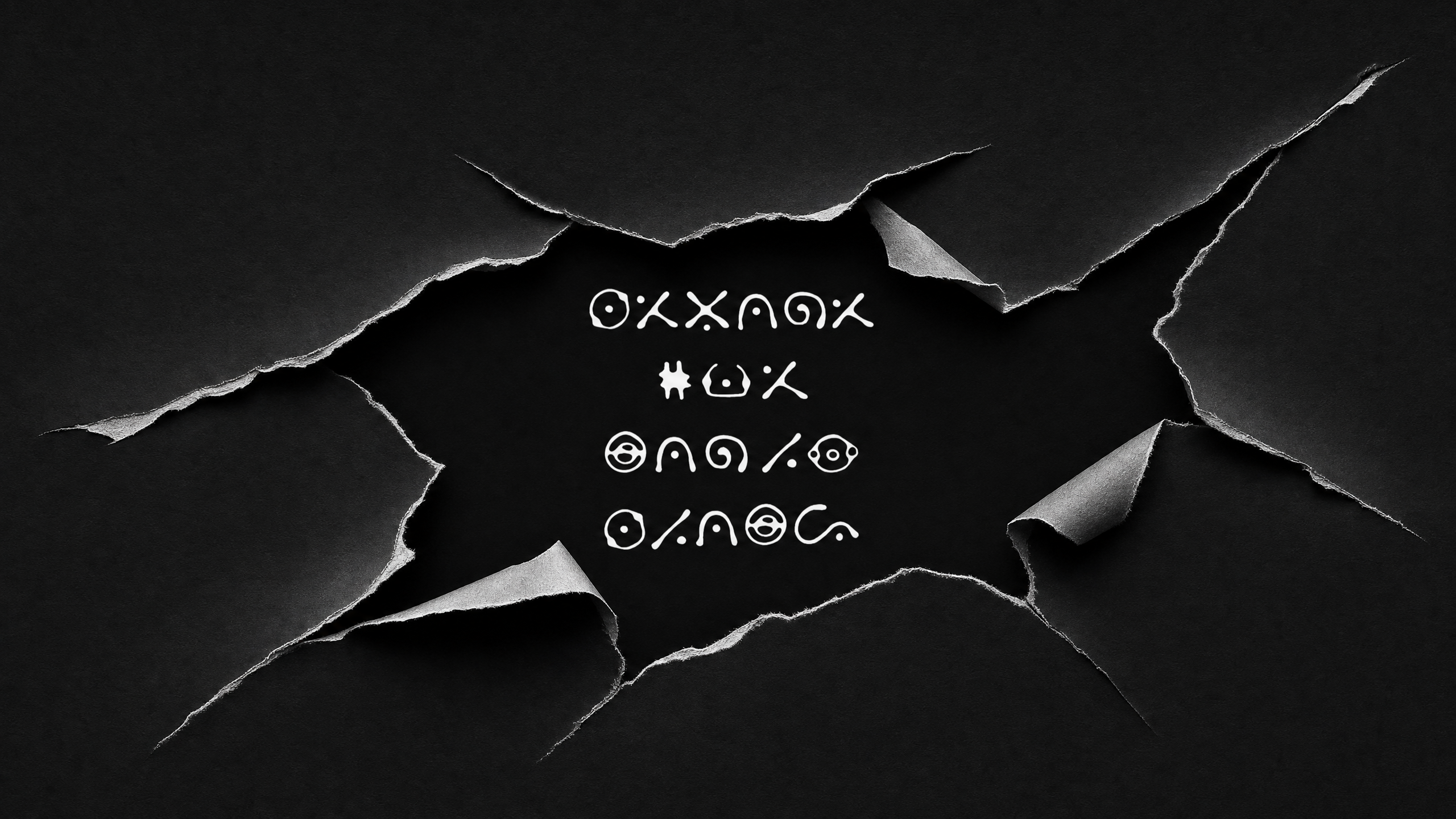 A black background with torn edges revealing mysterious symbols in white. This is the cover of Erykah Badu and Alchemist's new album