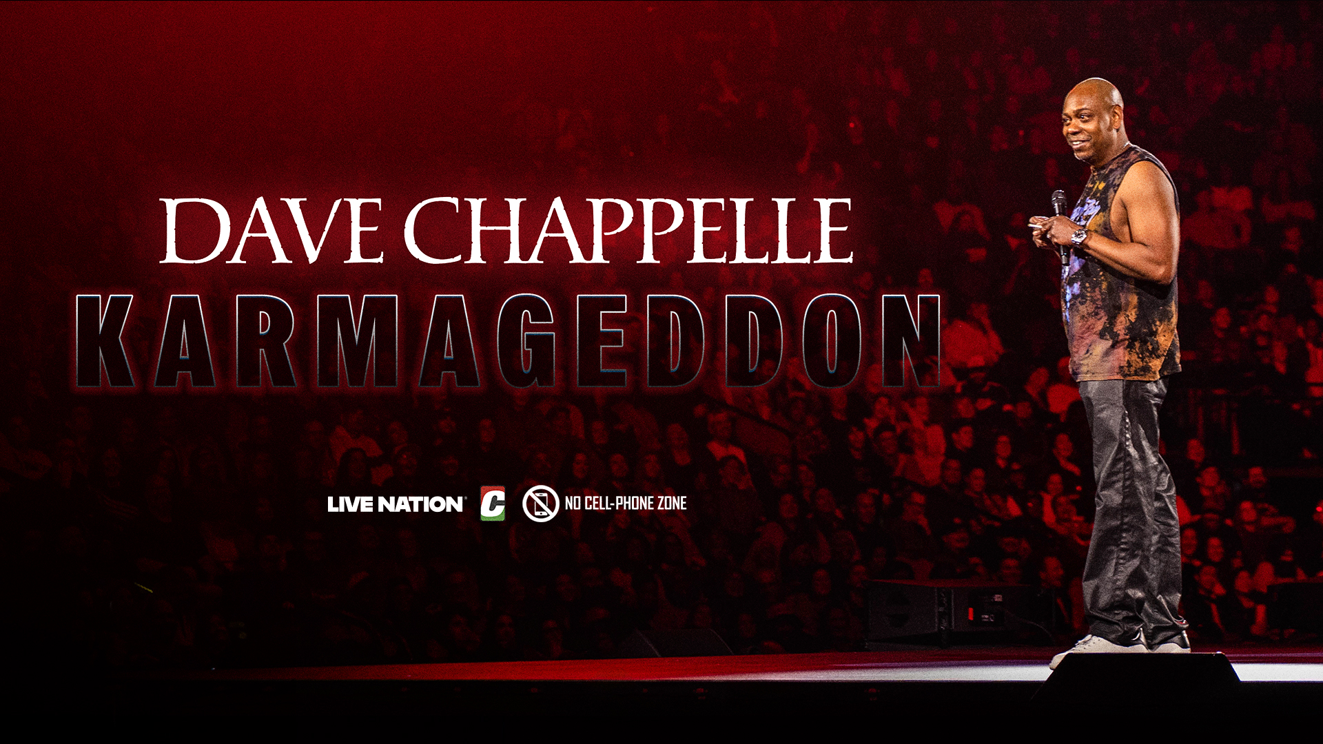 Dave Chappelle on stage with a microphone, promoting "Karmageddon." Audience in the background, red lighting.