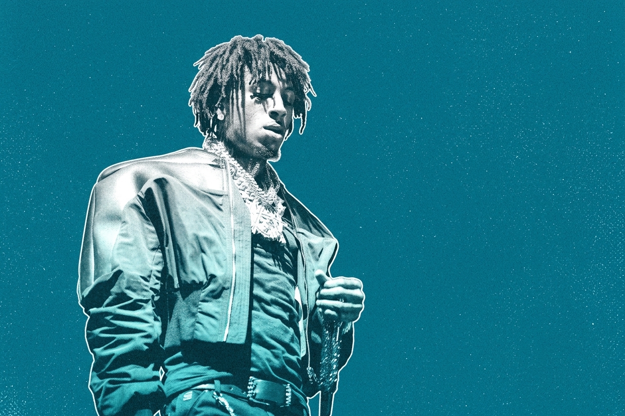 A person with dreadlocks in a stylish jacket against a blue background, looking to the side.