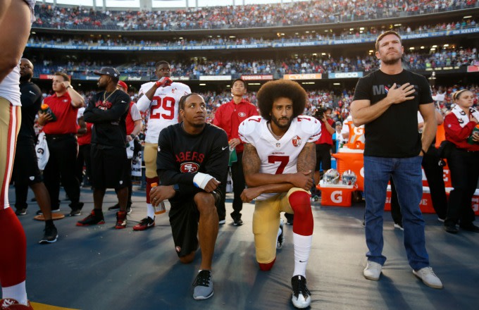 Colin Kaepernick kneels during the national anthem before a preseason game.