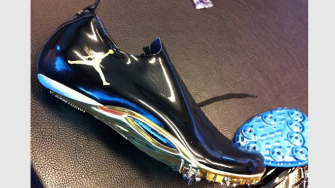 white and gold nike spikes