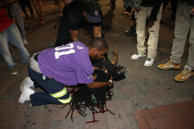 Demonstrated comfort a wounded protester.