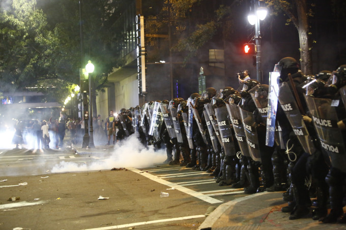 Police clash with protesters.