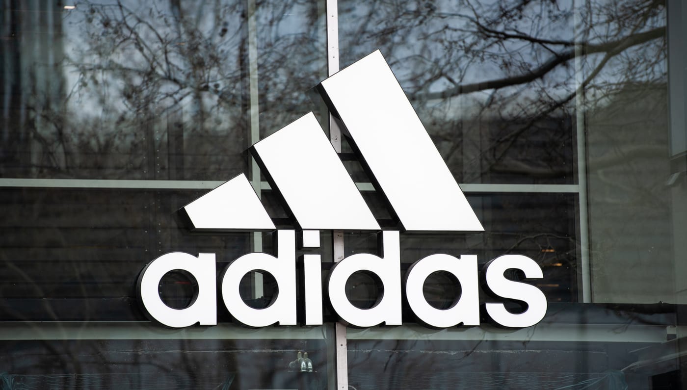 The company's logo hangs on the façade of the Adidas store