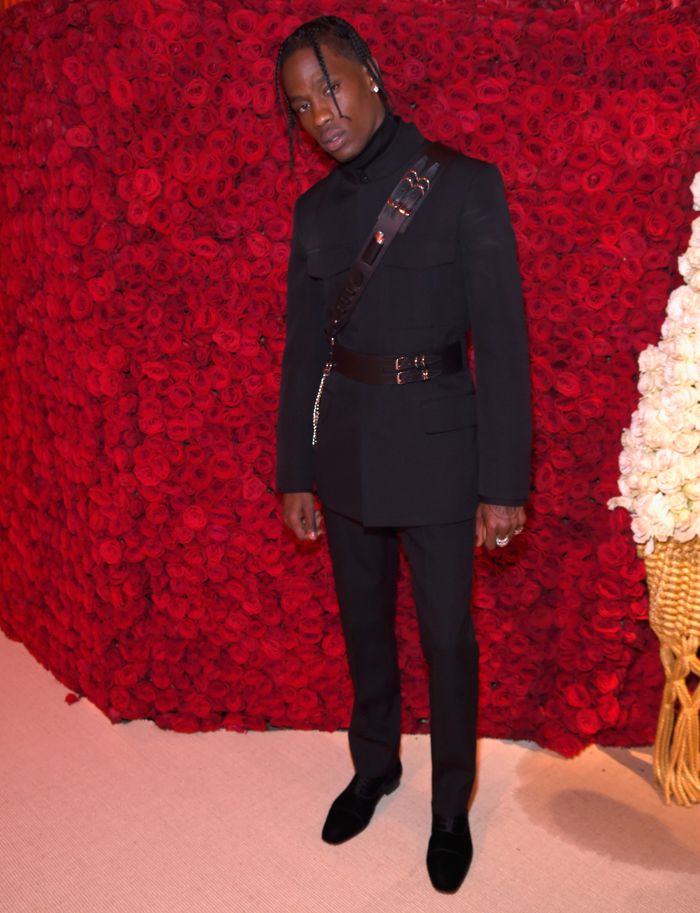 ic: Travis Scott's suave formalwear, accessorized with leather harnesses, pictured at the Met Gala 2018. Image via Getty/Kevin Mazur/MG18