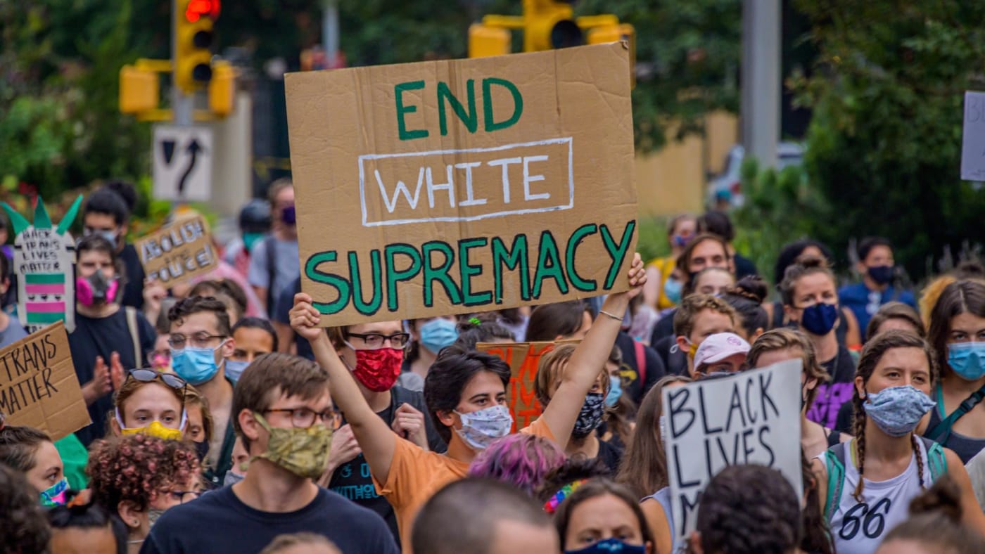 A participant holding a End White Supremacy sign at the protest.
