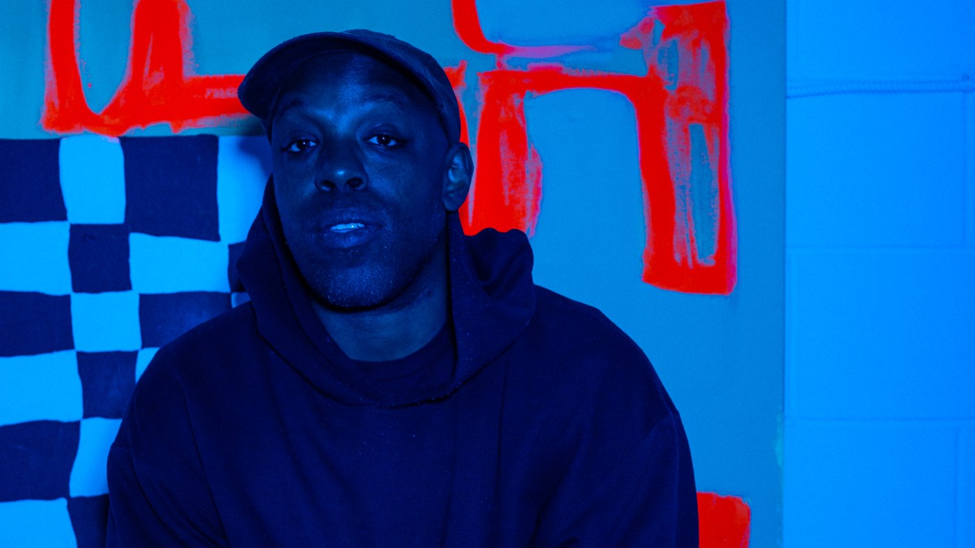 Artist Shad in a blue tinged room