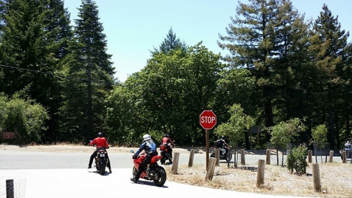 motorcycle riders stop sign