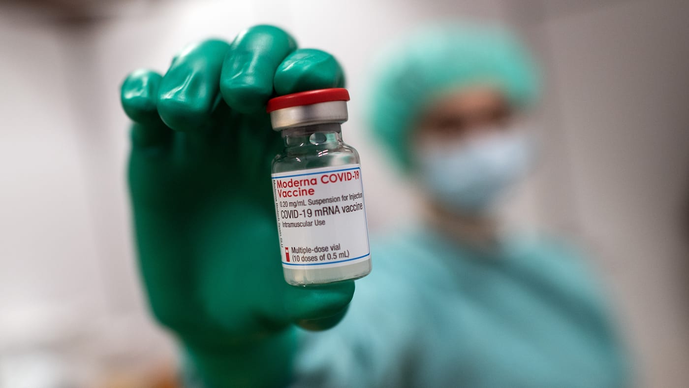 A doctor holds a jar of Moderna's vaccine against Covid 19