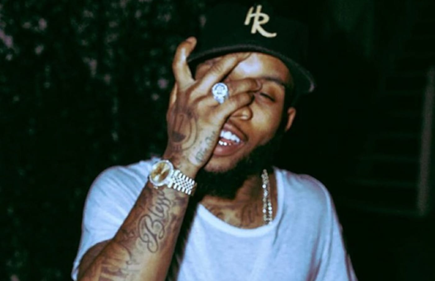 Tory Lanez posing with hands in front of face