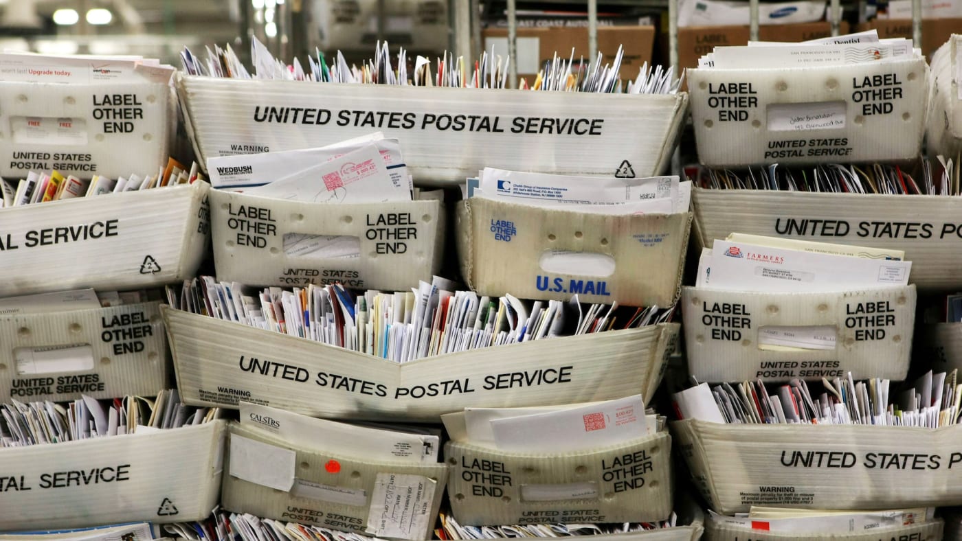 Stacks of boxes holding cards and letters are seen at the U.S. Post Office sort center.