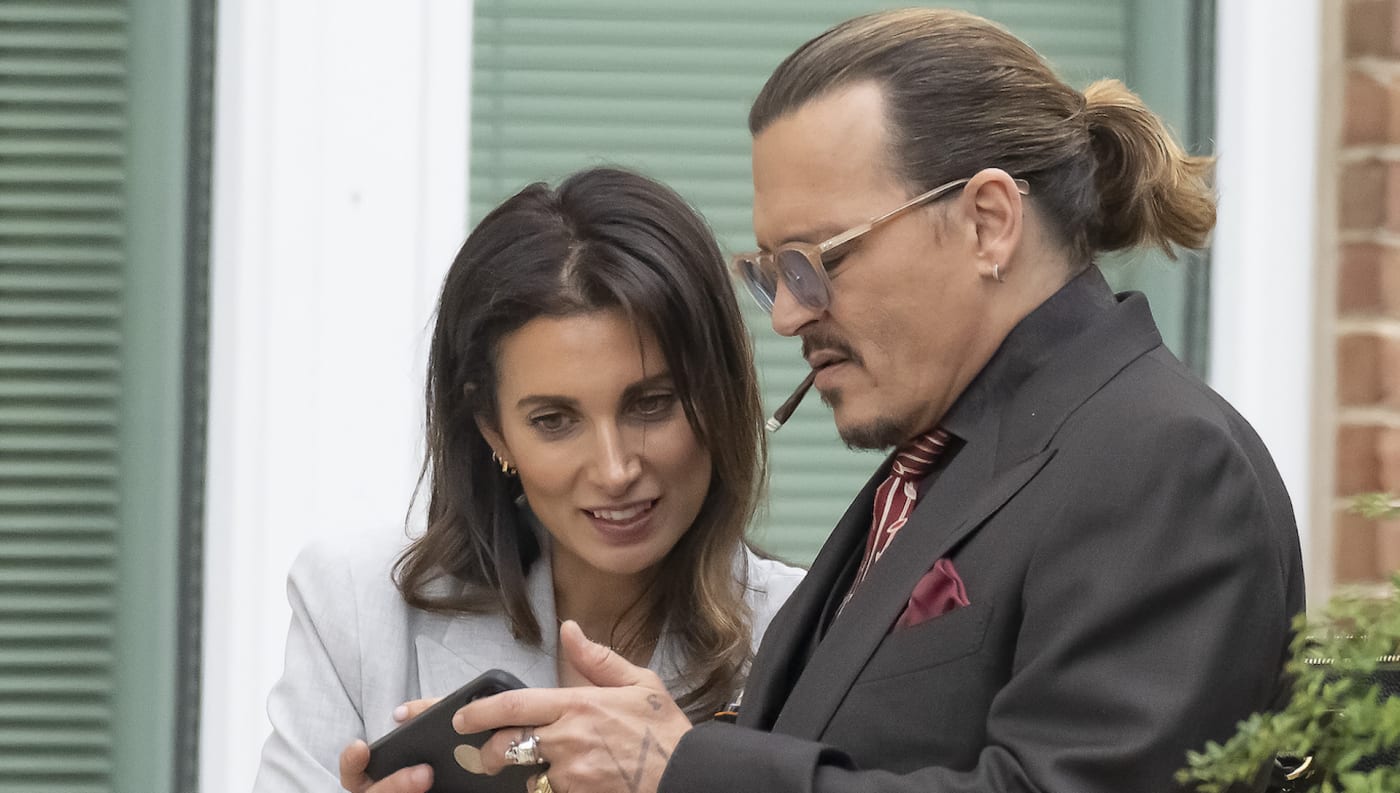 Johnny Depp look at his smartphone with his UK legal Counsel Joelle Rich