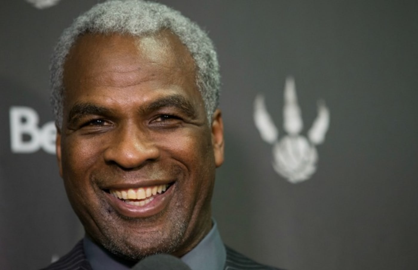 Charles Oakley laughs during a press conference.