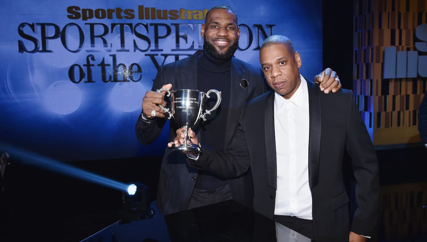 LeBron James and Jay Z pose onstage with an award during the Sports Illustrated Sportsperson of the Year Ceremony