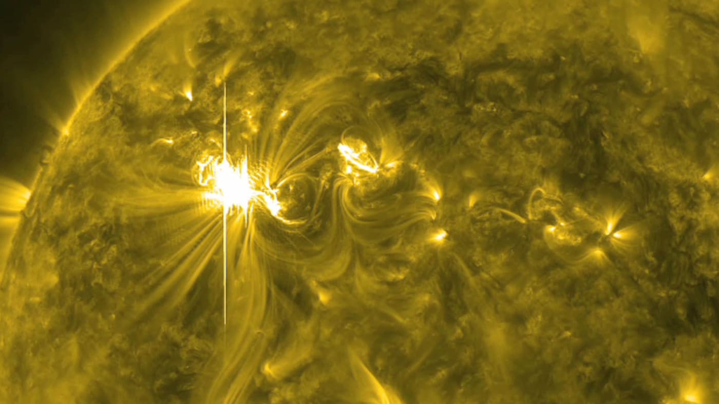 a X5.4 solar flare, the largest in five years, erupts from the sun's surface.