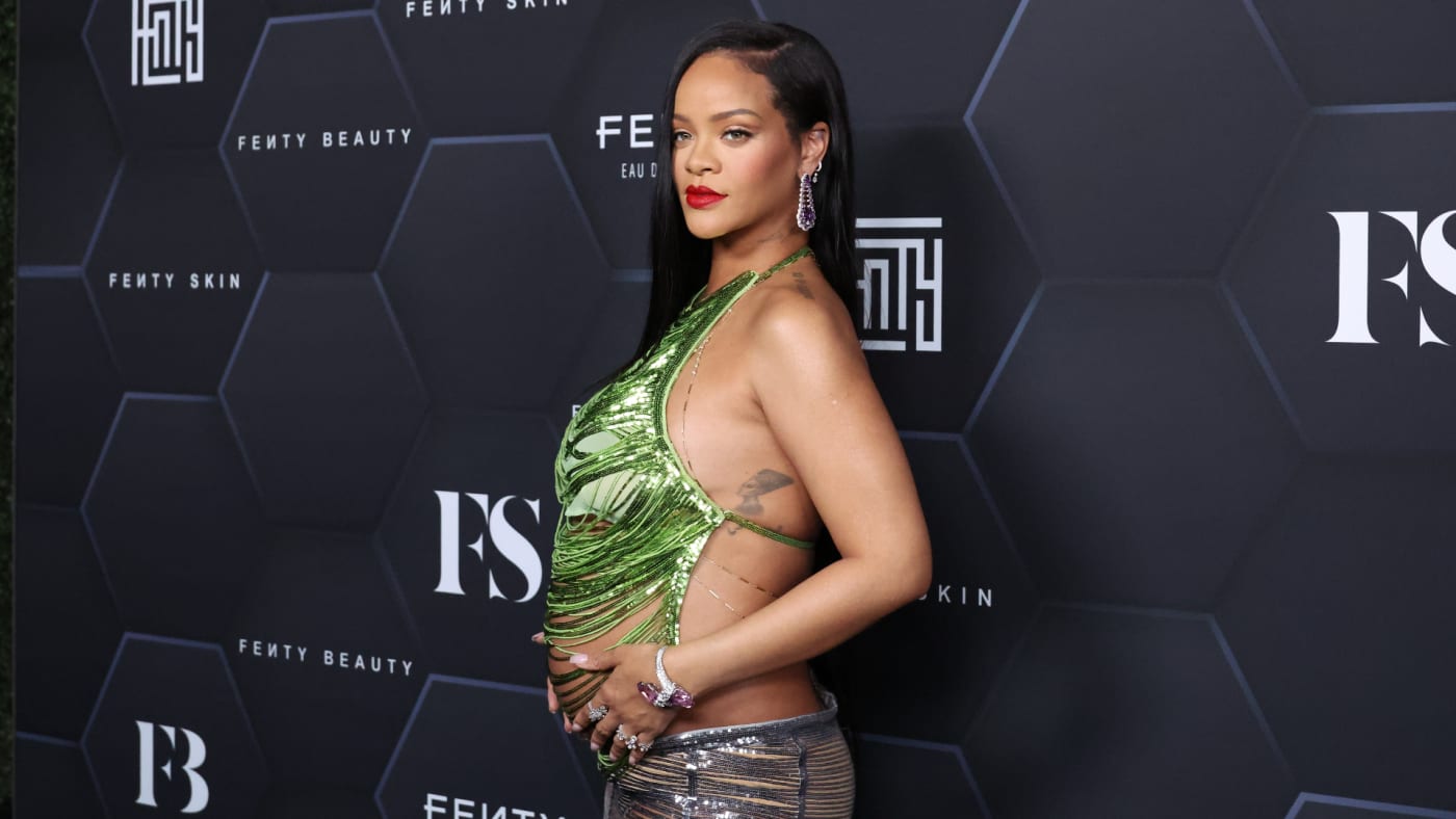 A pregnant Rihanna poses for photos on the red carpet.