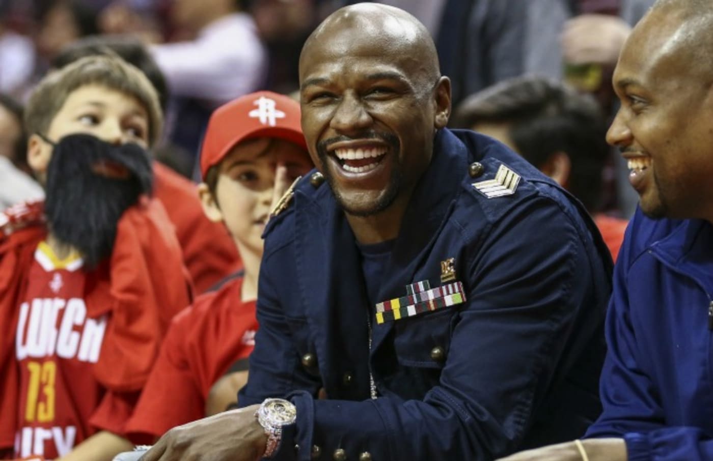 Floyd Mayweather laughs during an NBA game.