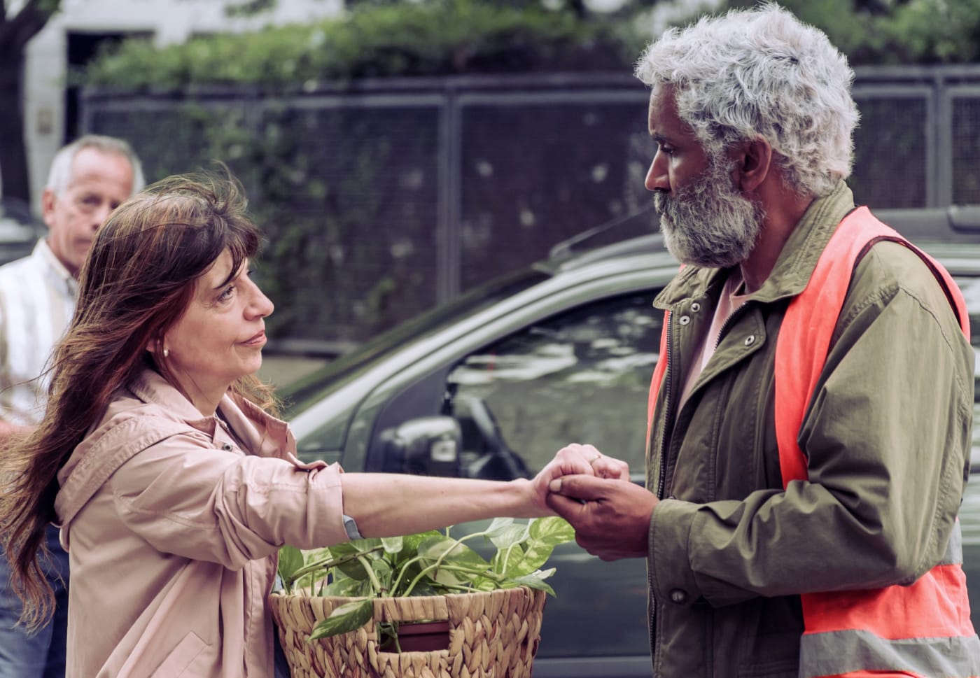 A man holds a woman's hand in the movie Togo
