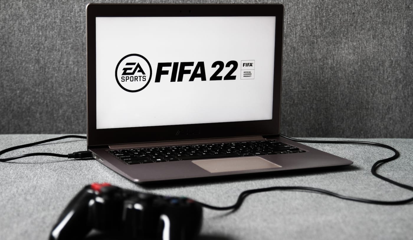 EA Sports' FIFA 22 logo displayed on a laptop screen