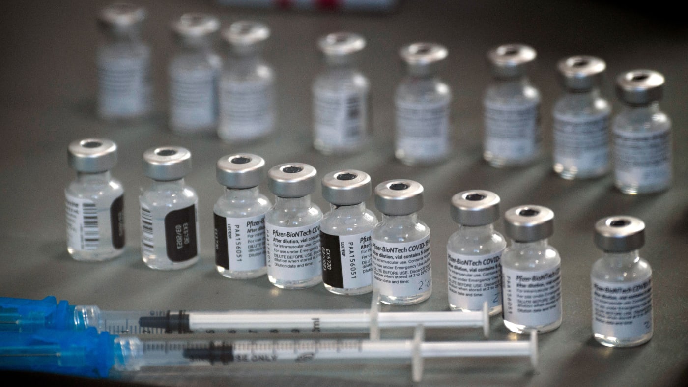 Photo of syringes and vials of the Pfizer vaccine.