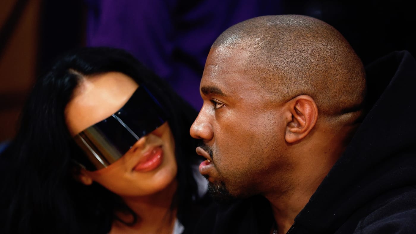Rapper Kanye West and girlfriend Chaney Jones attend a game