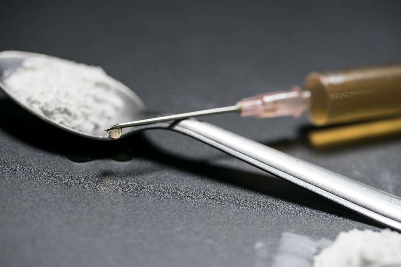 A spoonful of cocaine and a syringe of heroin