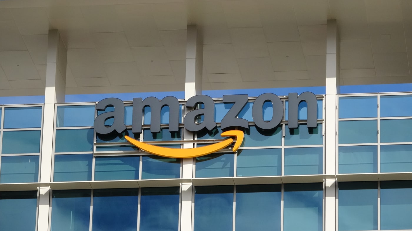 Sign with logo on facade of the regional headquarters of ecommerce company Amazon.