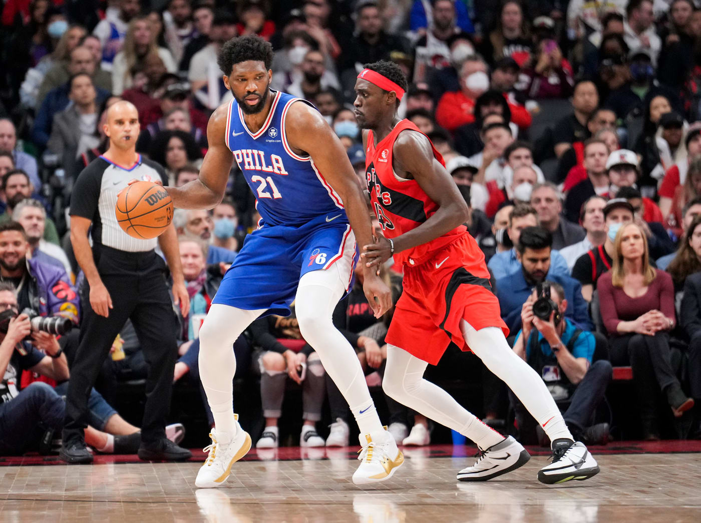 Joel Embiid #21 of the Philadelphia 76ers is guarded by Pascal Siakam #43 of the Toronto Raptors