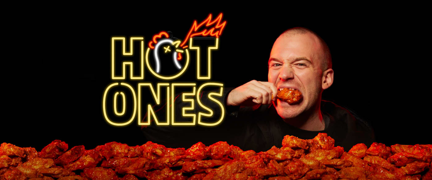 Neon Hot Ones Logo with Sean Evans Angrily Eating a Chicken Wing Next to it.