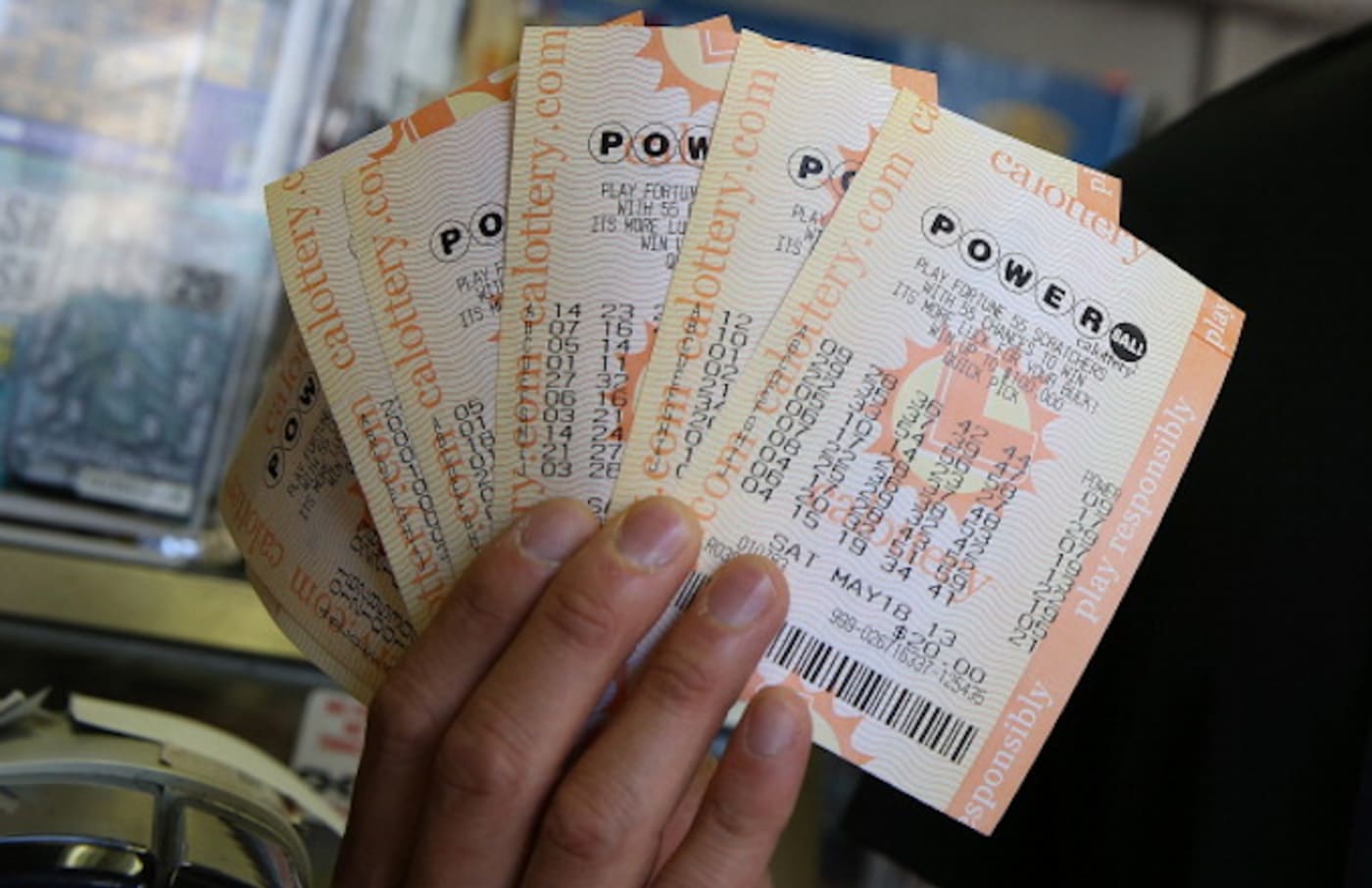 A customer holds $140 worth of Powerball tickets