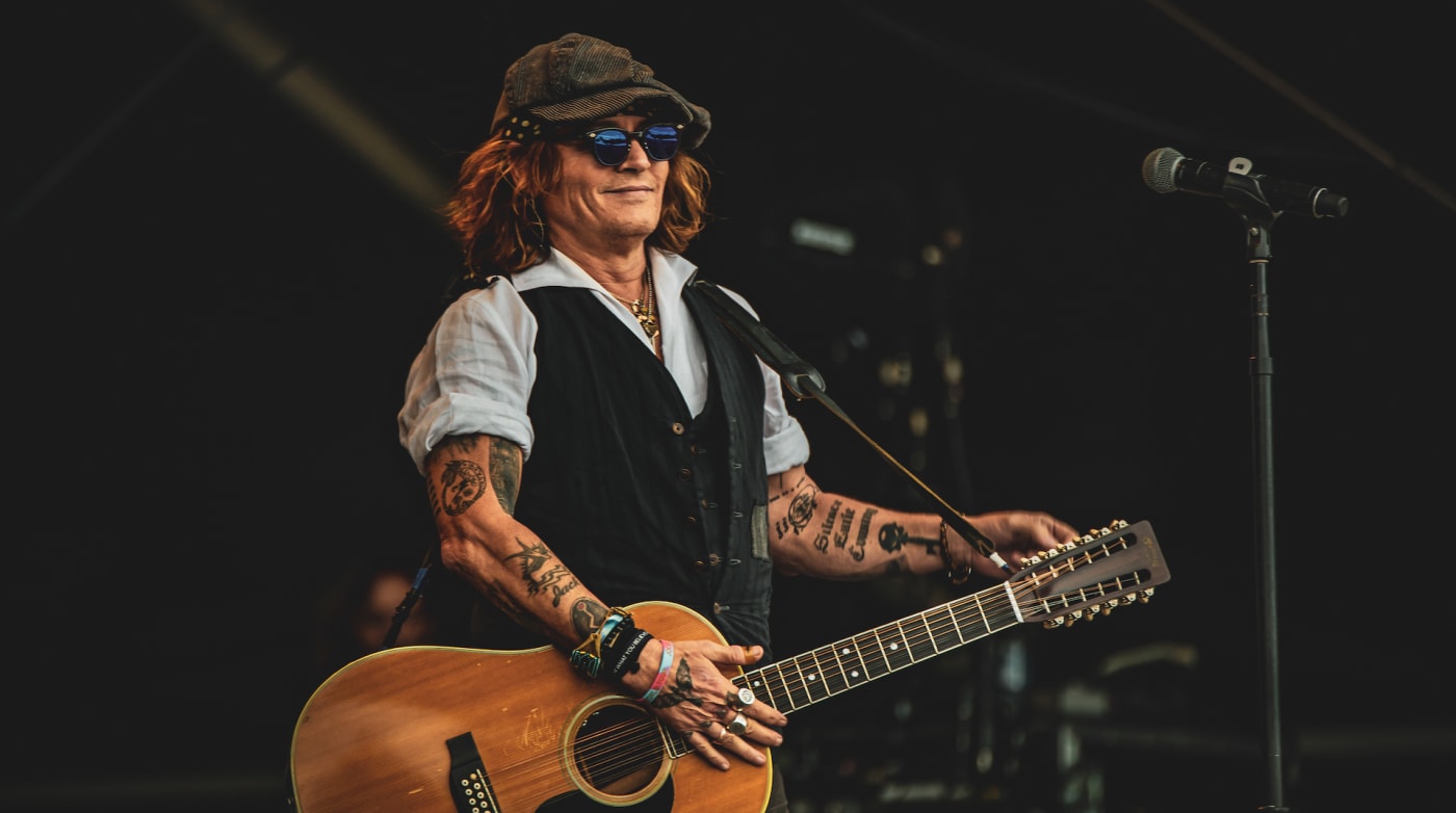 Johnny Depp performs on stage with Jeff Beck (not pictured) during the Helsinki Blues Festival