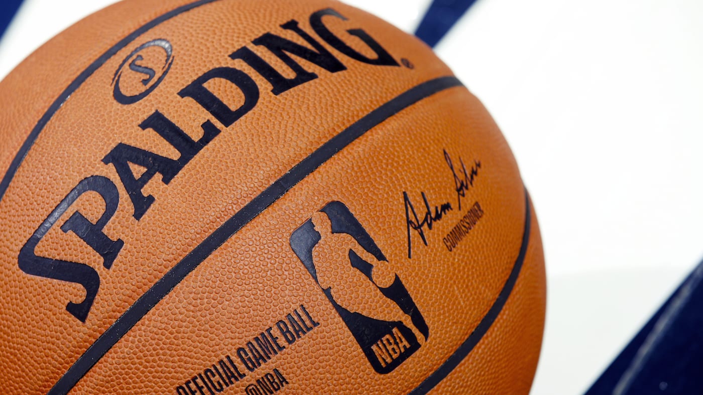 A detail view of official Spalding NBA logo basketball on the floor.