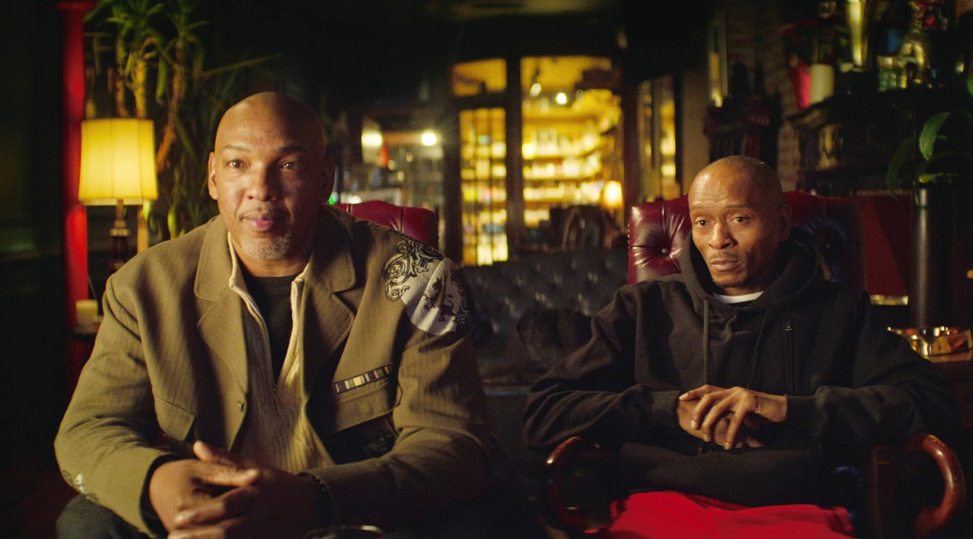 Two men being interviewed for a documentary.