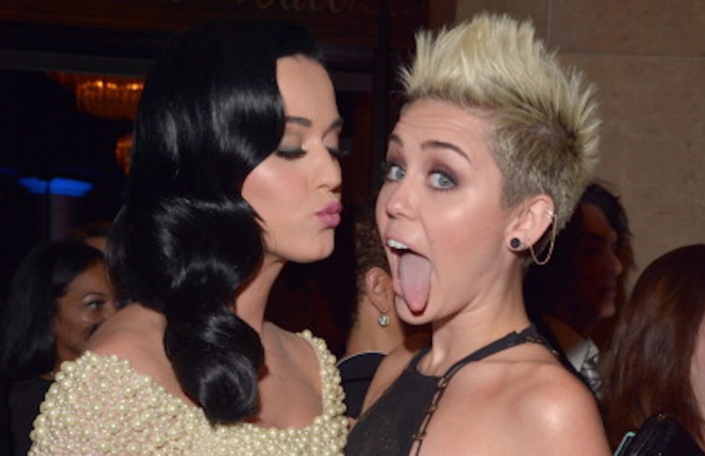 Katy Perry (L) and Miley Cyrus arrive at the 55th Annual GRAMMY Awards