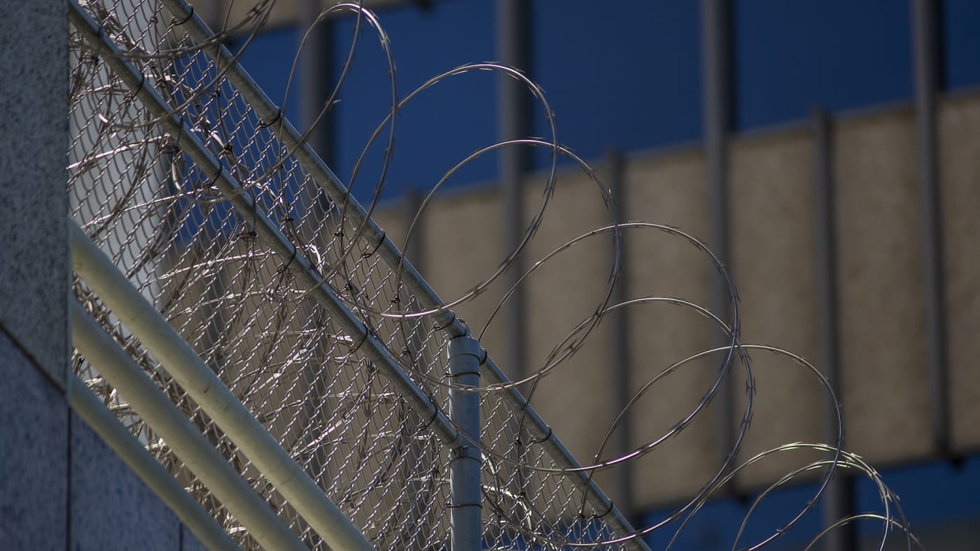 Razor wire is seen on the Metropolitan Detention Center prison