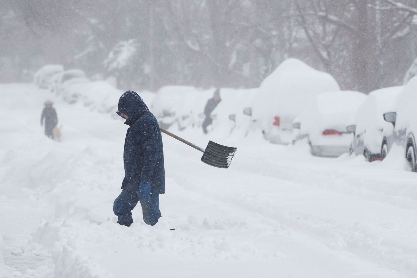 A person shovels snow from a driveway in Toronto, Ontario, Canada, on January 17, 2022.