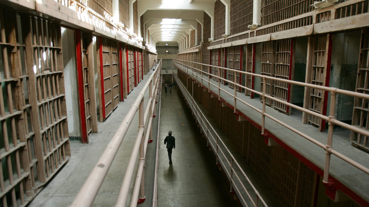A National Park Service ranger walks down "Broadway" in the main cell block on Alcatraz Island.
