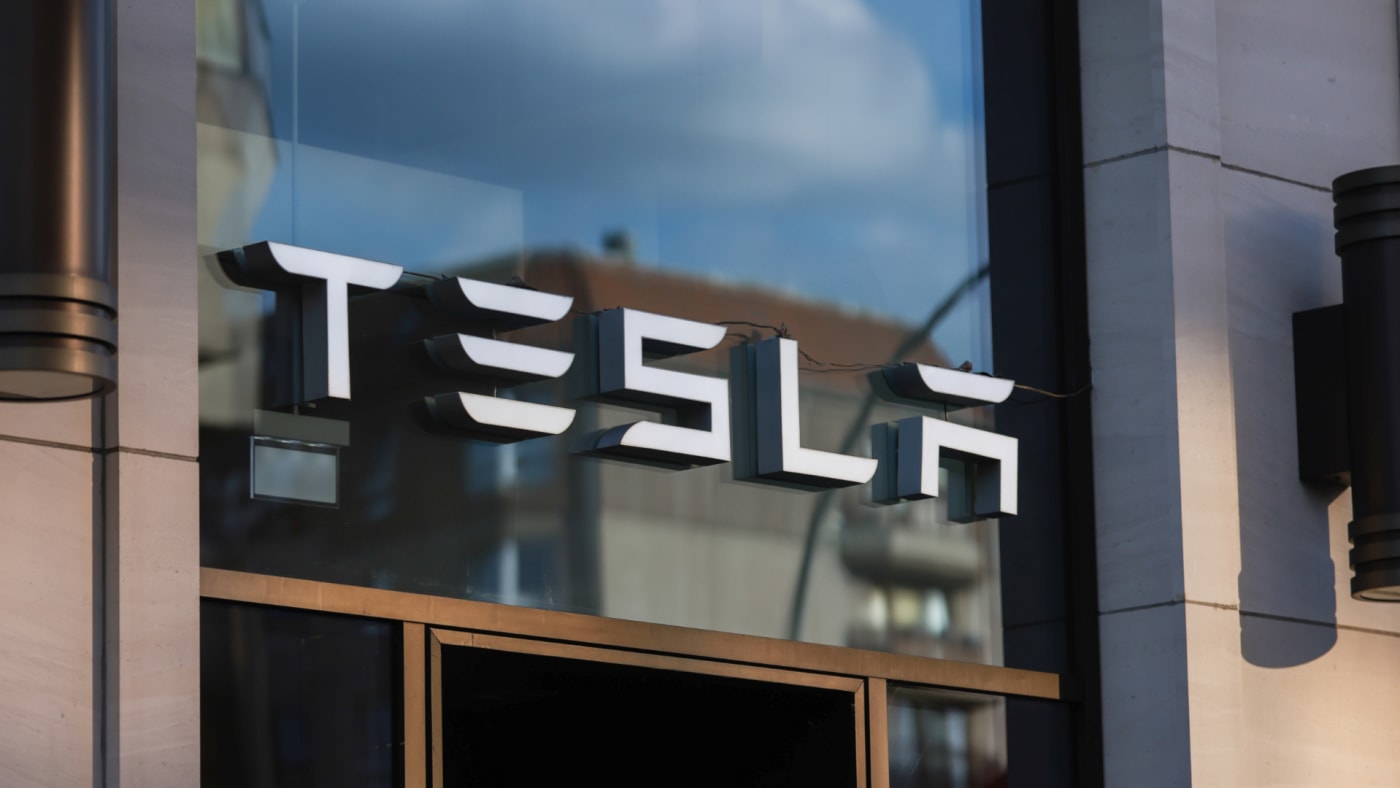 A logo for the Tesla company is shown