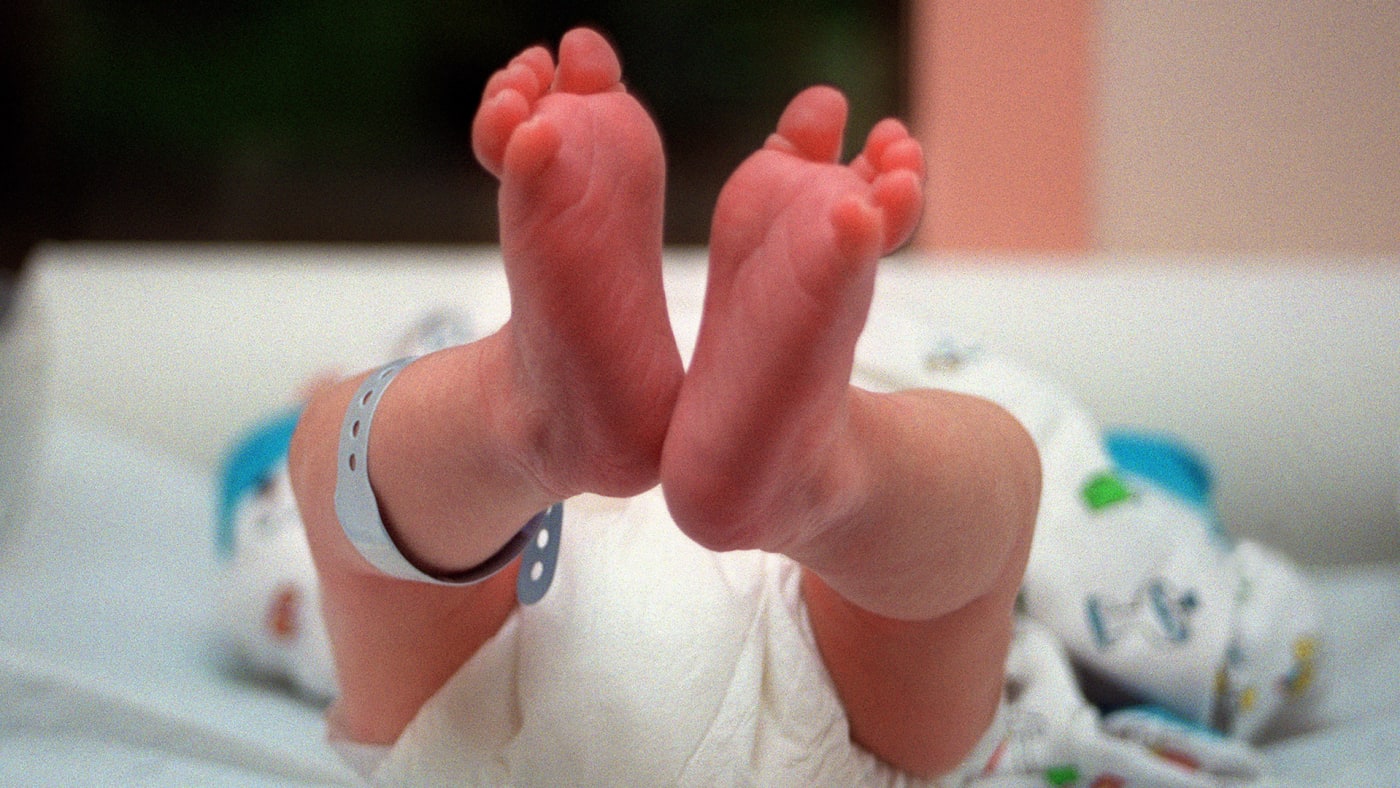 Photograph of a baby in a hospital nursery