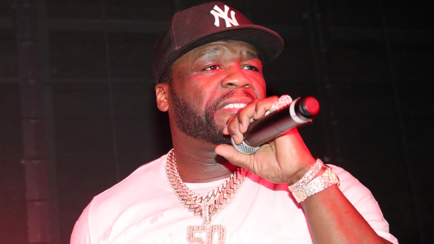 50 Cent is pictured holding a microphone