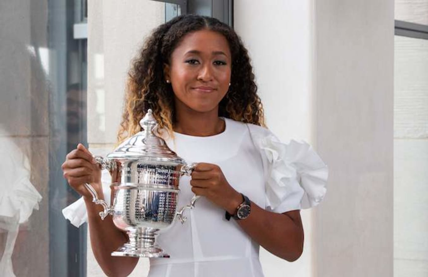 Naomi Osaka of Japan poses with her championship trophy.
