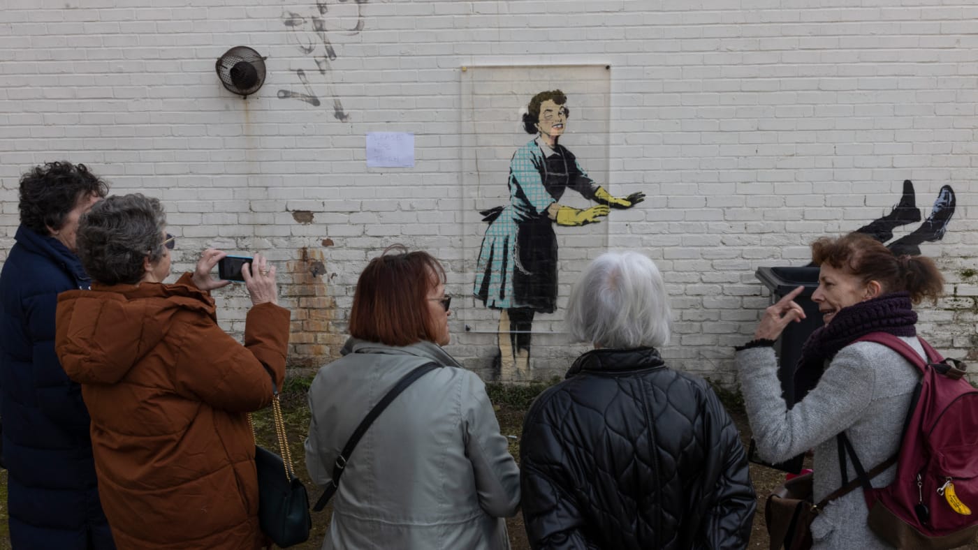 Banksy mural is pictured with admirers