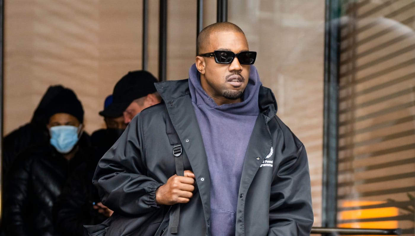 Kanye West is seen walking with a bag
