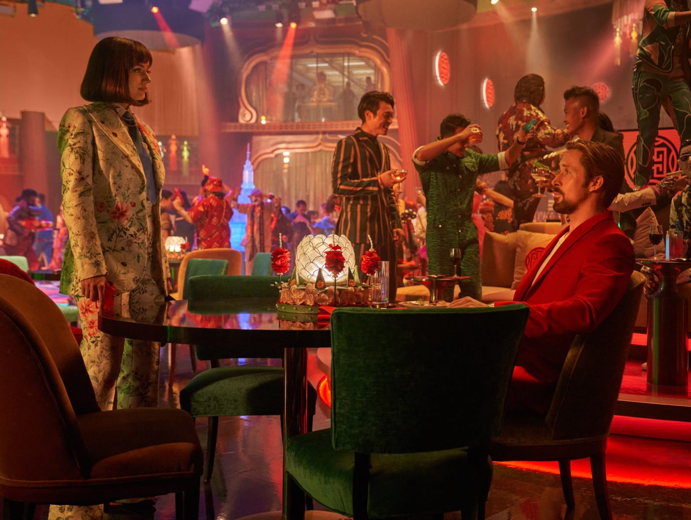 Ryan Gosling sits across from Ana De Armas.