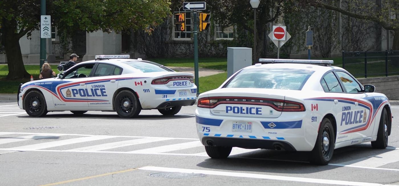London Ontario police cars parked on front lawn