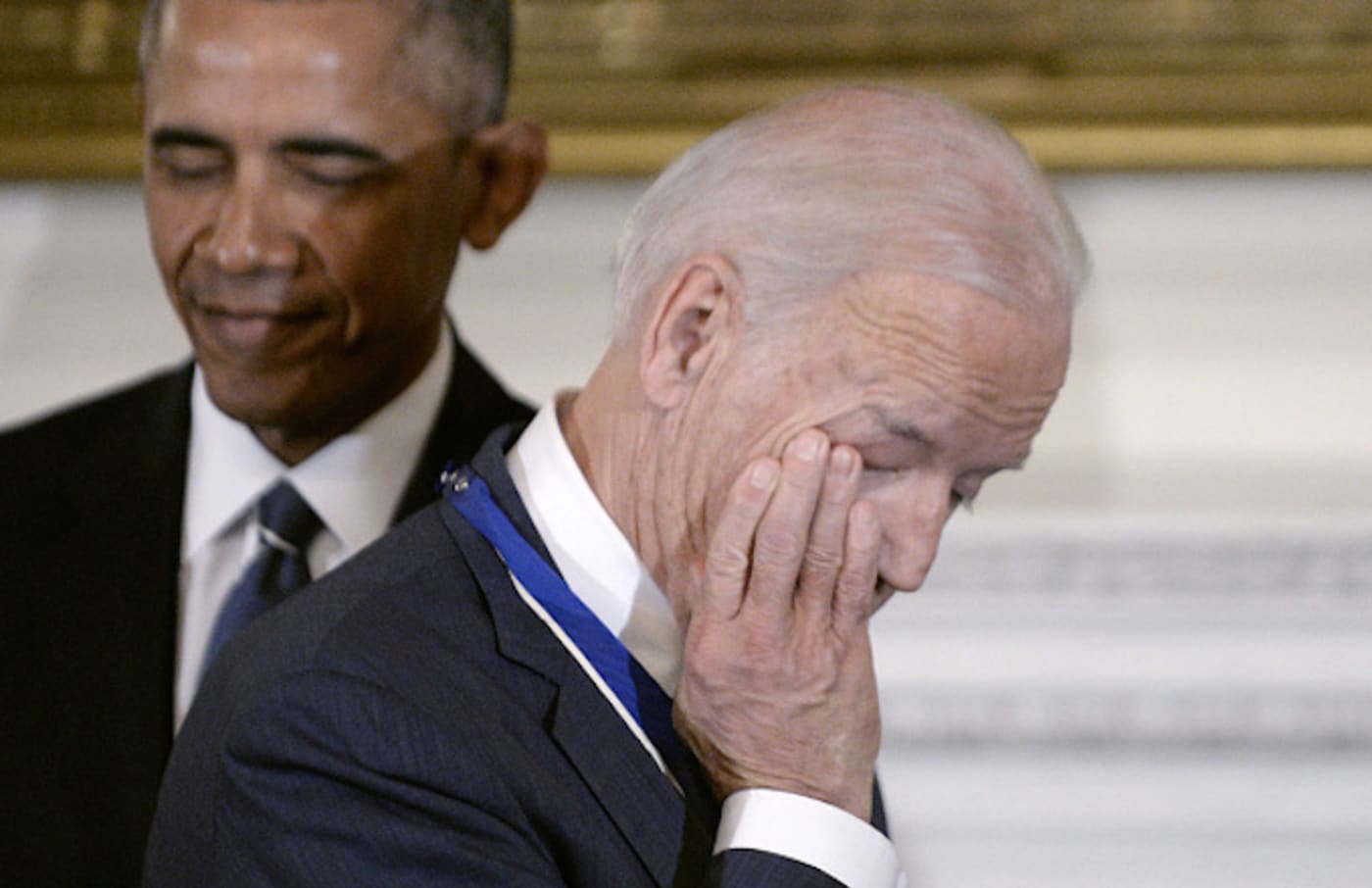 Vice President Joe Biden wipes his eyes after Obama presented him with Medal of Freedom