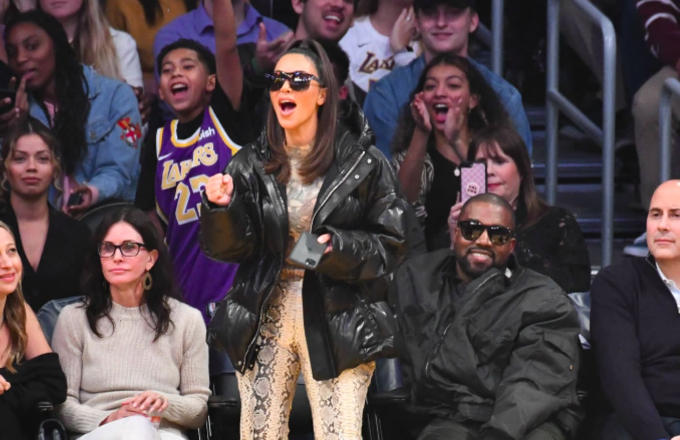 Kim Kardashian and Kanye West attend a basketball game